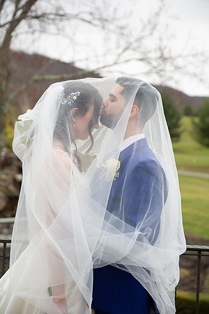 Groom kissing the bride under the veil at Falkirk Estate
