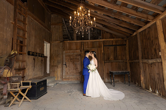 Beautiful Black Bride and Groom kissing in the Barn at The Tides Estate