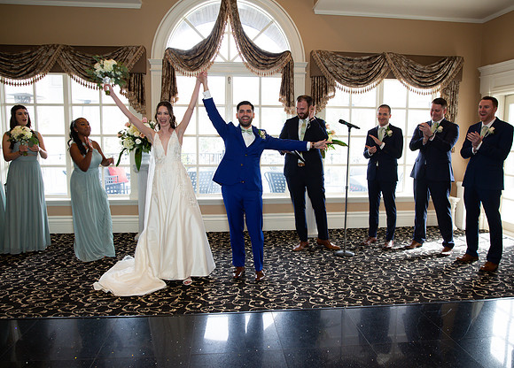 Bride and Groom  shows victory gestues after the I do