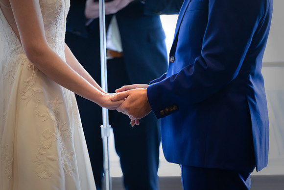 Bride and Groom hand in hand at the ceremony